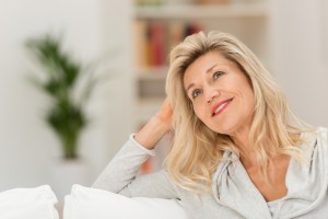 Attractive woman sitting daydreaming